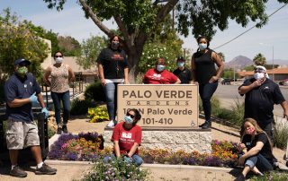 six women standing around the palo verde gardens sign.