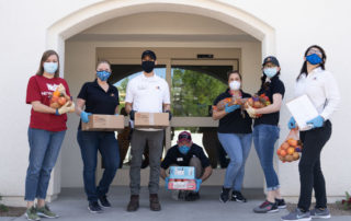 five females and two males working in the Golden Groceries at Senior Communities photo galleries