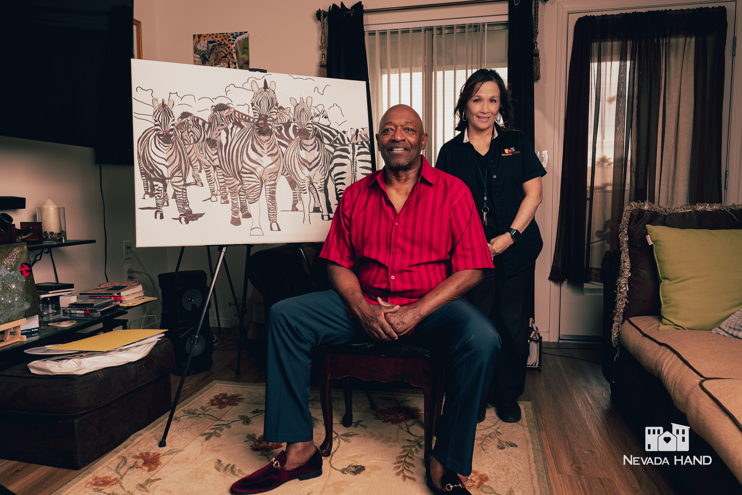 George and Lani pose with a painting.